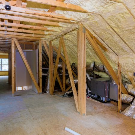 Foam plastic insulation installed in the sloping attic of a new frame house.